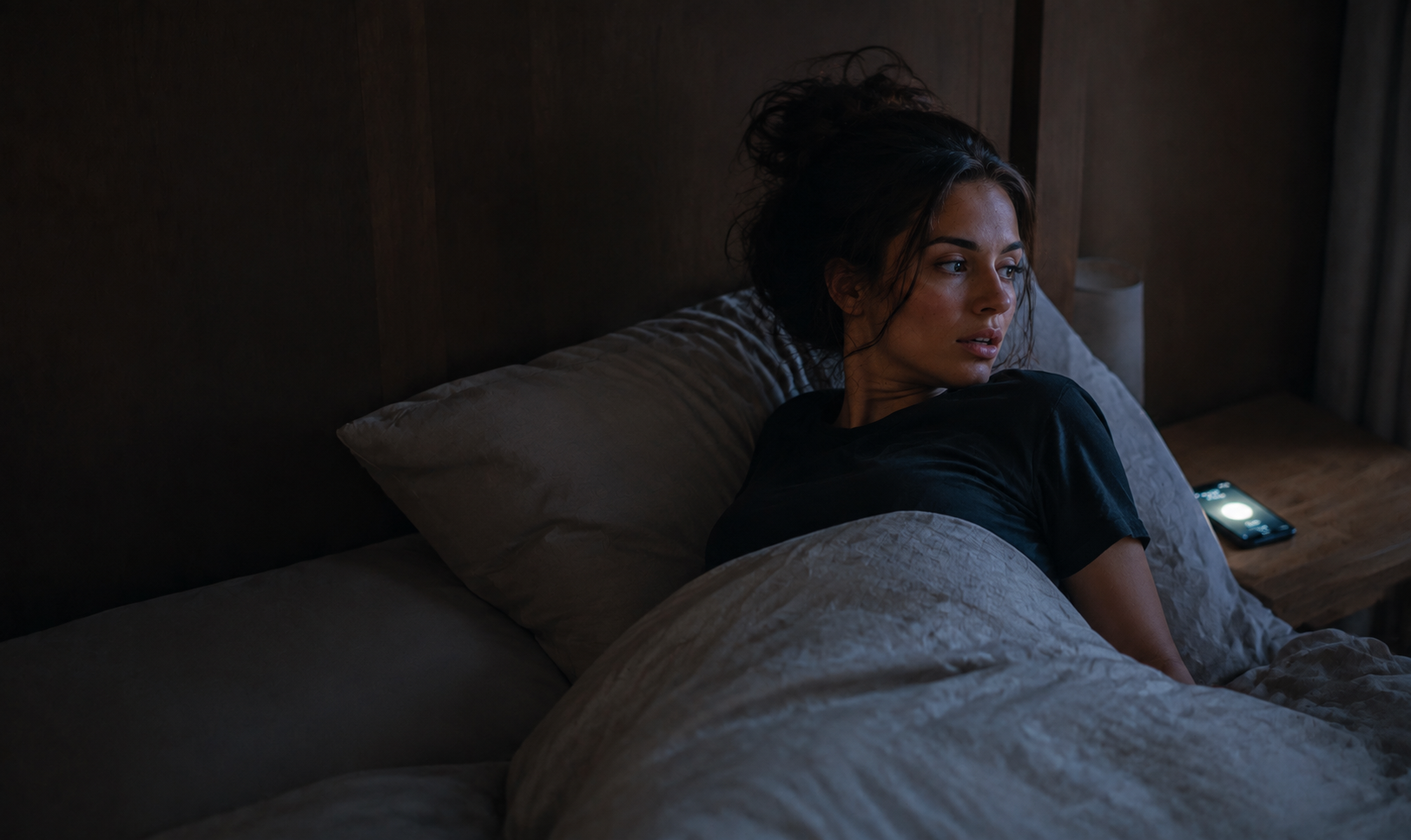 Woman startled awake by a loud phone alarm